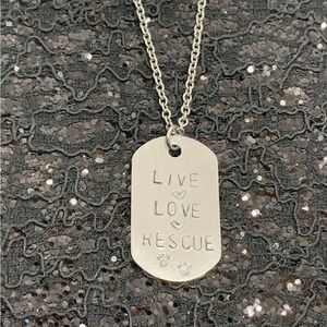 Live, Love, Rescue is hand-stamped on aluminum dog tag on chain.